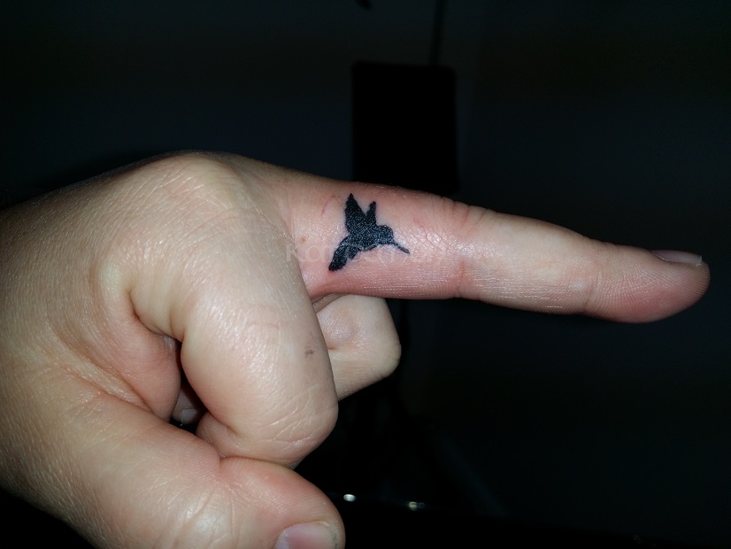 Finger humming bird tattoo